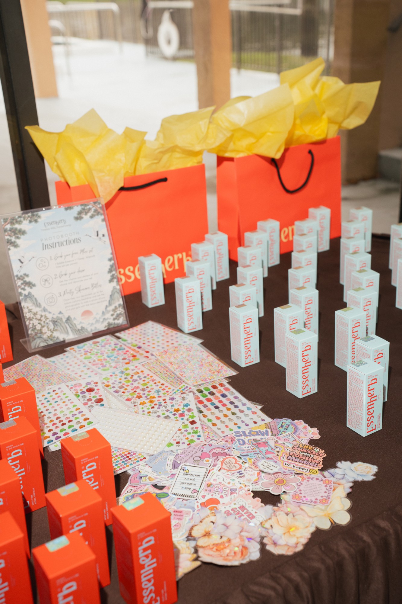 Photobooth instructions with orange gift bags and sticker sheets