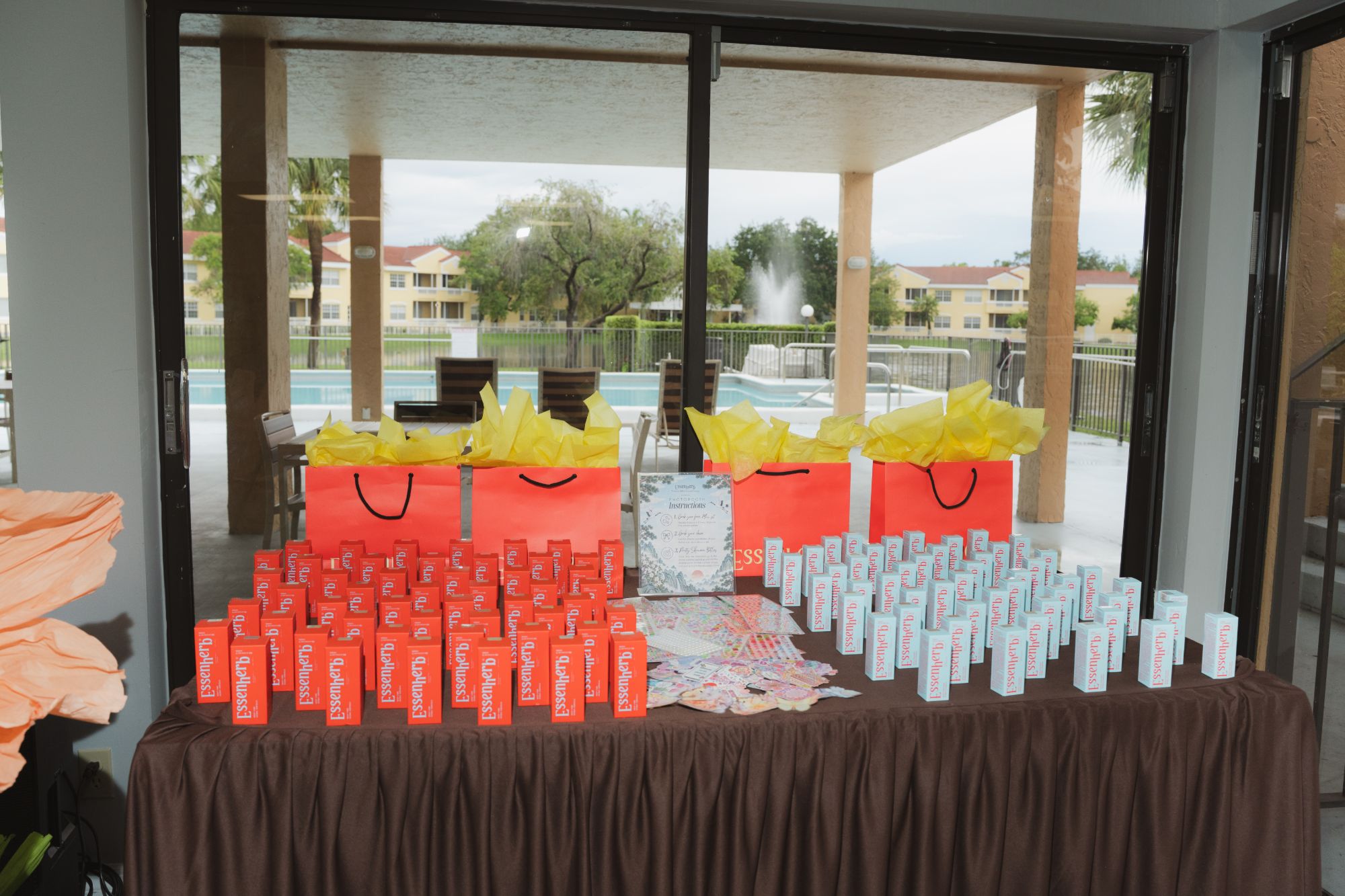 Wide setup shot with the four tables and yellow tissue bags
