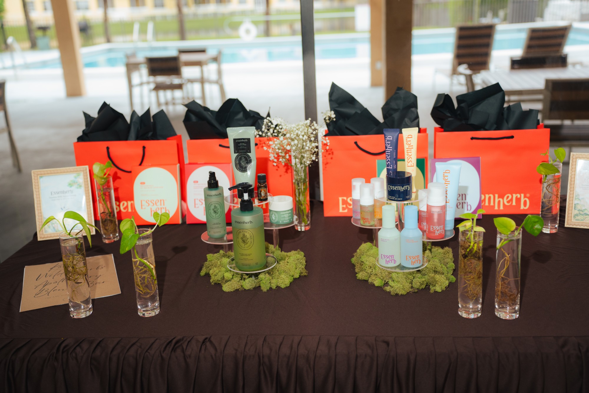 Tables with orange bags and product staging, viewed at an angle