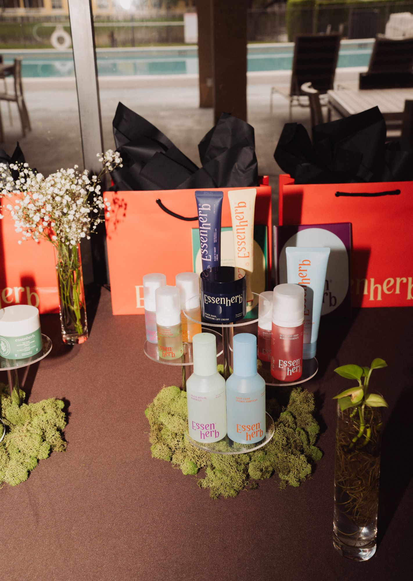 Golden-hour product display with gift bags and moss