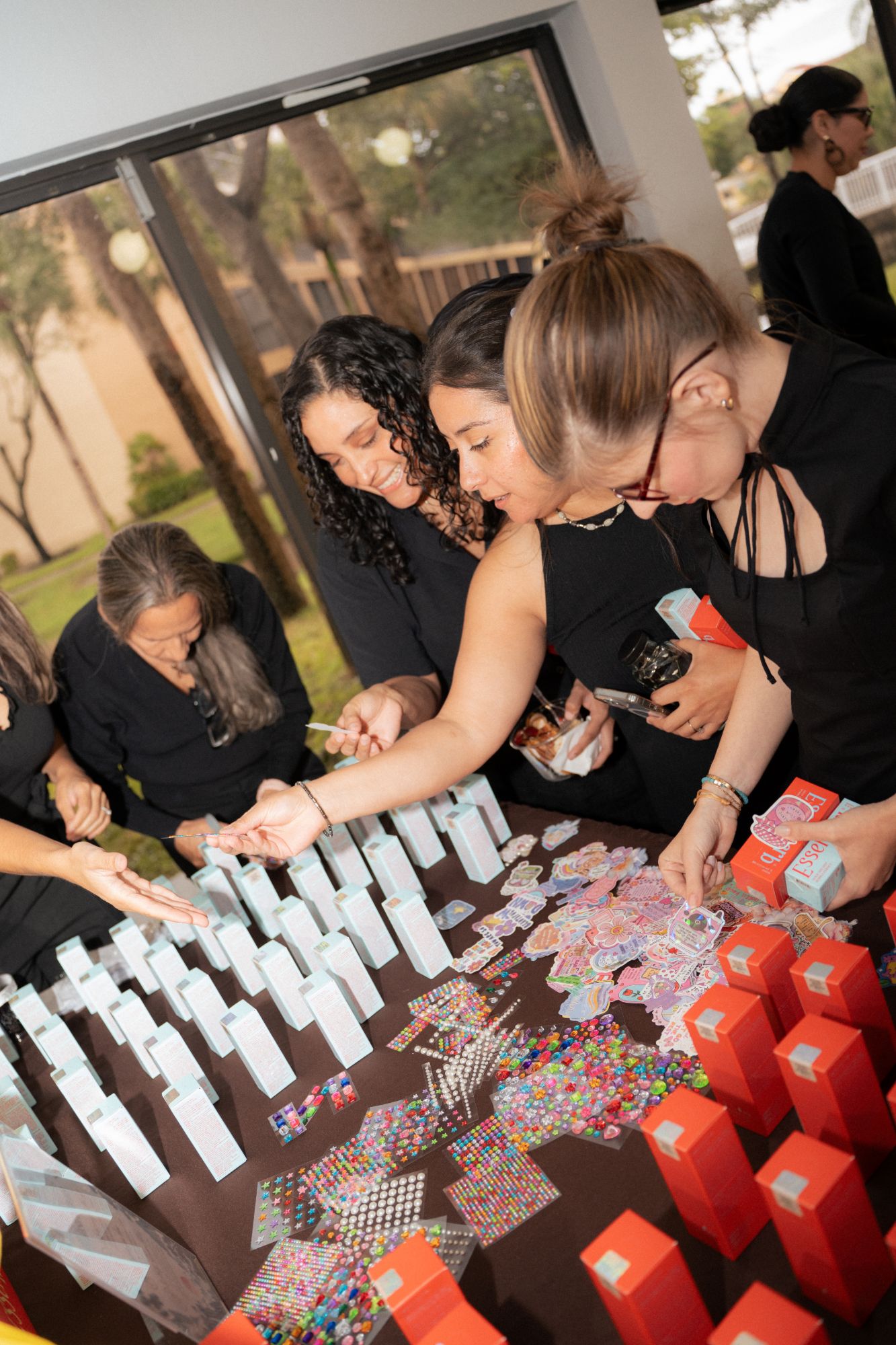 Guests browsing the sticker sheets and product boxes together