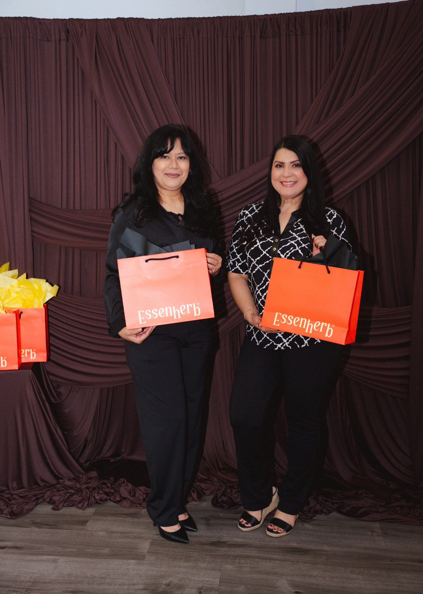 Guests at the photobooth backdrop with their goodie bags