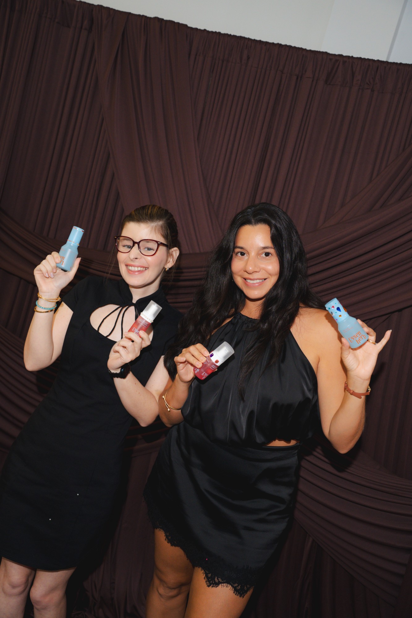 Two guests at the photobooth holding up their favorite picks