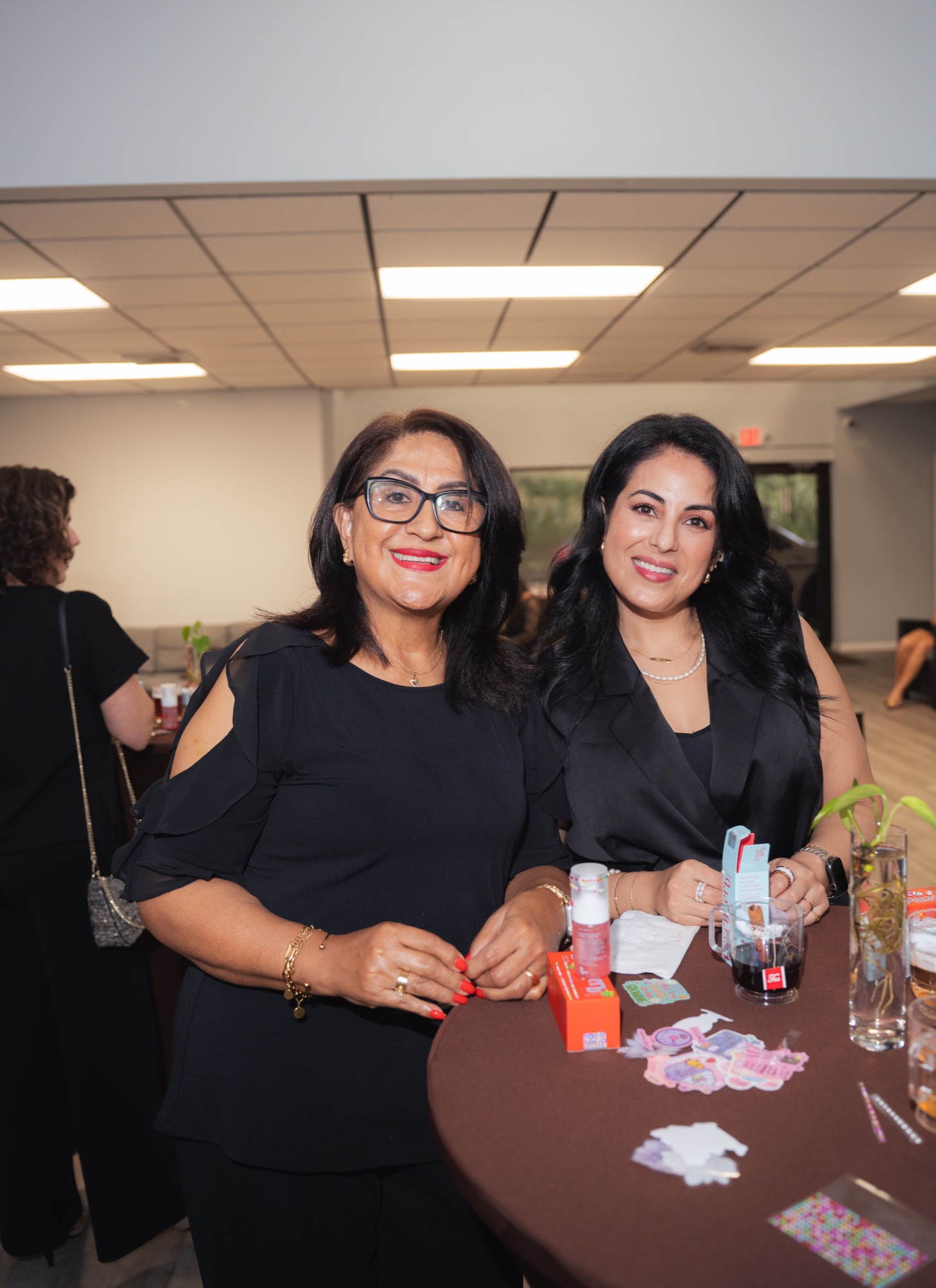 Two guests at a cocktail table with products