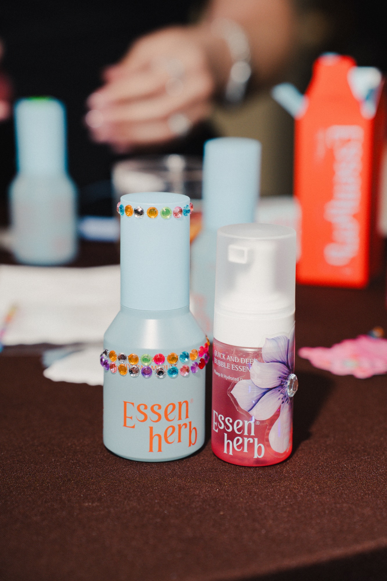Close-up of decorated skincare bottles with rhinestone stickers