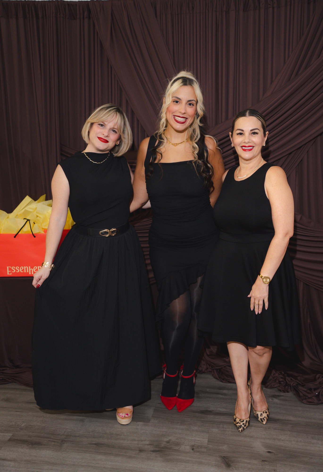 Three guests full-body at the photobooth backdrop