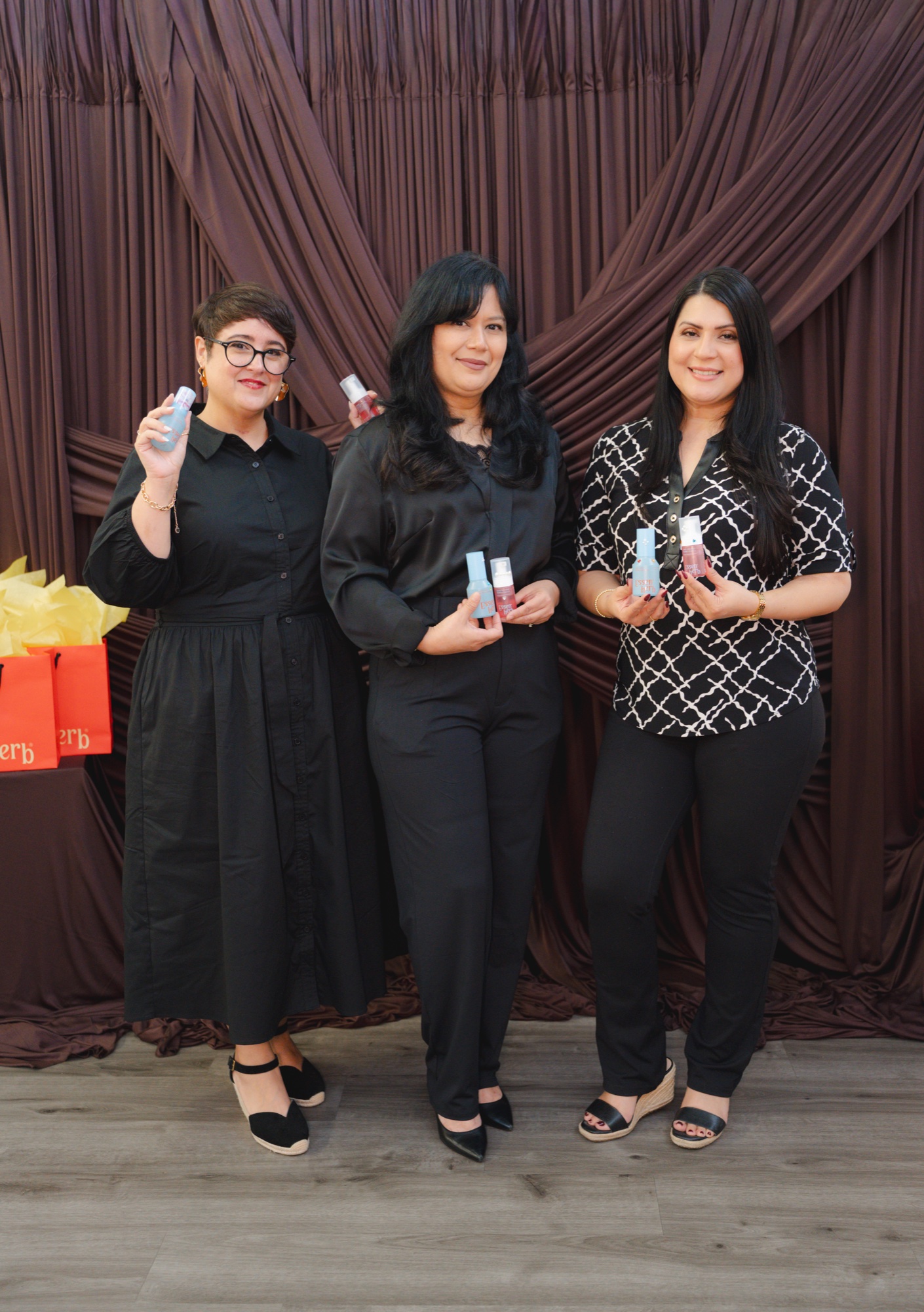 Three guests together at the photobooth backdrop